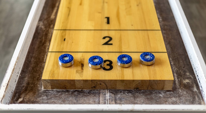 Find your perfect fit at Aspire Lenox Park close-up of shuffleboard table and pieces